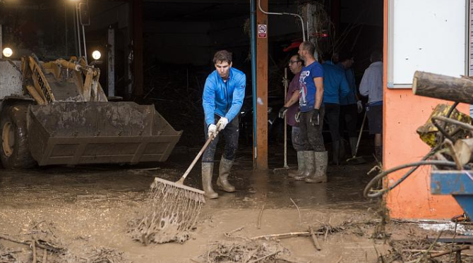 The flash flooding in Majorca killed 12 people, with island-born tennis star Rafael Nadal coming home to help out. 